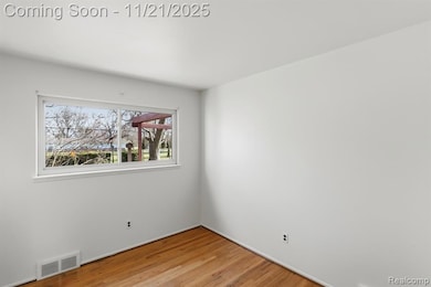 Spare room with light wood-type flooring and baseboards
