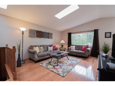 Skylights in the spacious living room flood the ar