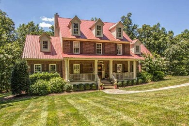 Lying on 5 acres, this brick home is surrounded by