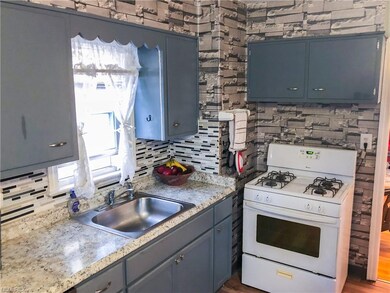Kitchen with updated counters and backsplash.