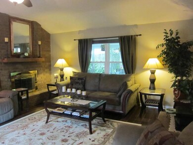 Another view of your den with the brick wood burni