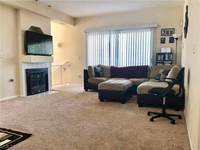 Living Room with gas fireplace and balcony
