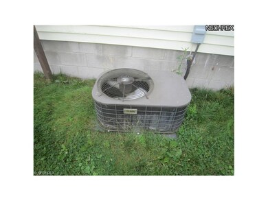Close-up of Luxaire air conditioner condenser.