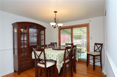 Dining room with Hardwood, Chair rail, and sliding
