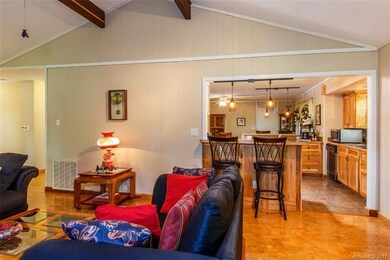 The living room is open to the sunroom as well as 