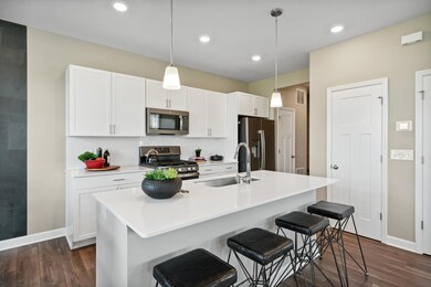 Open concept, the home's kitchen space is highly desirable and features a large kitchen island serving as the perfect centerpiece for cooking and entertaining! *Photos of model home; colors and finishes will vary.