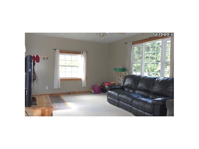 Spacious livng room with tile entry.