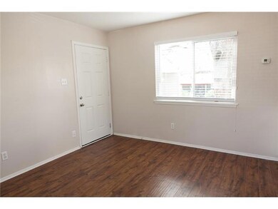 Unfurnished room with baseboards and dark wood-style floors