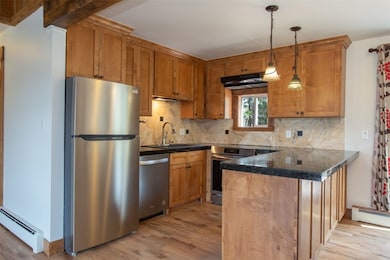 Kitchen with stainless steel appliances, baseboard