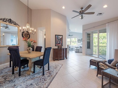 Tiled dining space with ceiling fan with notable c