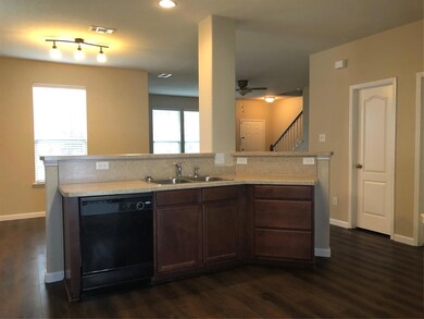 Kitchen looks into dining and living area