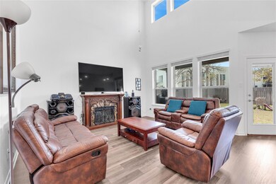 Living room with a high ceiling, baseboards, ligh
