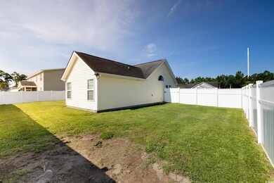 Rear view of property featuring a yard