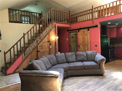 Living room looking up to the loft with two full-s