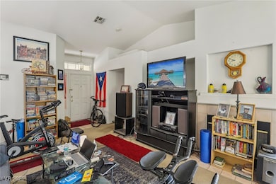 Living area with visible vents and lofted ceiling