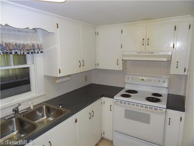 Kitchen. Bright white kitchen and all appliances; range/oven and regrigerator remain.