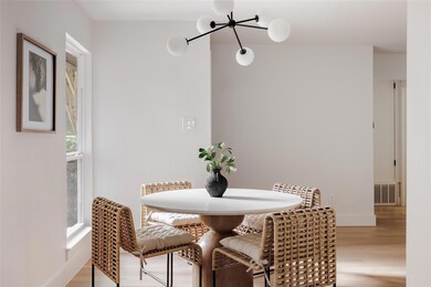 Dining area with wood finished floors and a chand