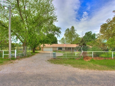 View of front facade featuring dirt driveway, fenc