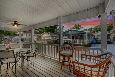 Deck at dusk with outdoor dining space, covered po