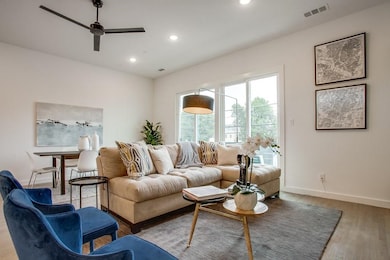 Living room featuring light wood-style flooring, recessed lighting, and ceiling fan
