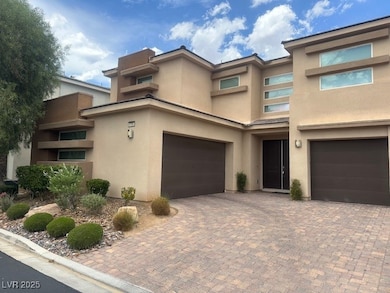 View of front facade with an attached garage, stuc
