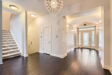Entrance foyer featuring visible vents, dark wood
