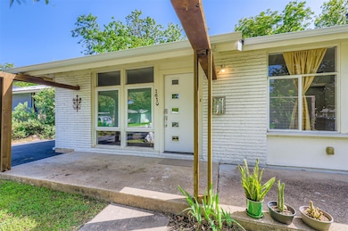 View of exterior entry with brick siding