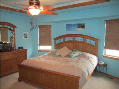 Master bedroom includes a coffered ceiling with li