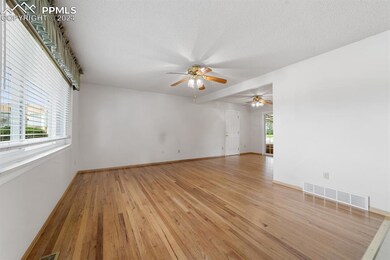 Main level living room offers open space, hardwood