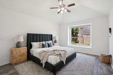 Located on the first floor, the oversized primary bedroom features vaulted ceilings, sleek flooring and private backyard views.