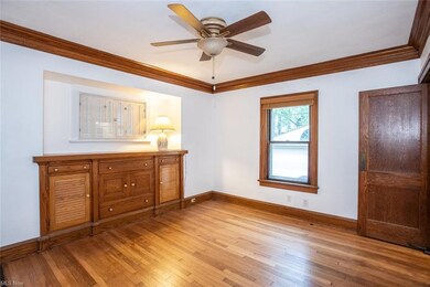 The formal dining room has a built-in buffet and a swinging door into the kitchen