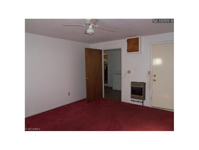 Family room with gas space heater and door to back