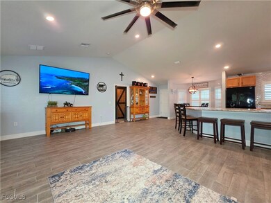 Living area featuring light wood-style floors, cei