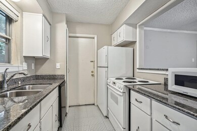 Kitchen with a textured ceiling, white electric ra