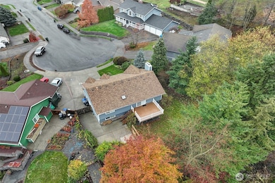 All the trees in this yard make it very private. There is RV parking and plug in on the side of the home.