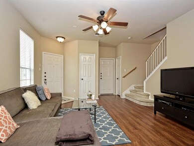 Living room with wood finished floors, a ceiling 