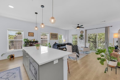 Kitchen featuring a center island, light wood fin