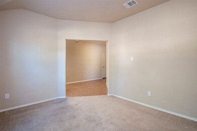 Empty room with light colored carpet and baseboards