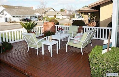 Welcoming Front Patio with White Picket Fence