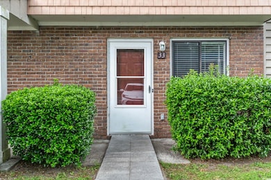 View of exterior entry featuring mansard roof and 