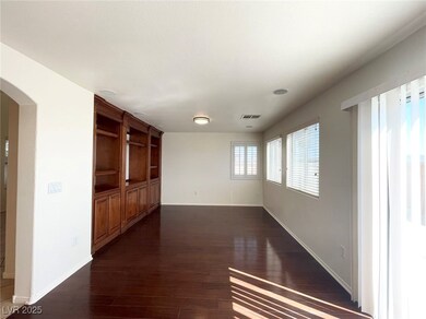 Unfurnished room with arched walkways and dark wood finished floors