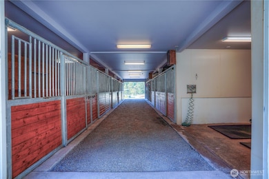 As you enter the barn you will be wowed! There are seven - 12 X 12 matted stalls, wash rack & tack room. You will notice the the gaveled center aisle for safety when training foals, but pavers could easily be added.