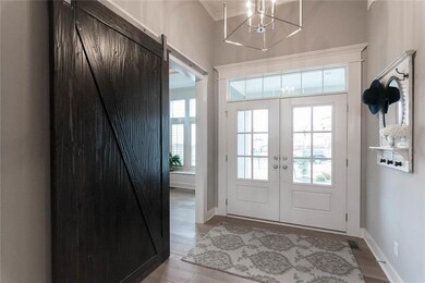 Front Entry with  Double Doors and Transom Above. 