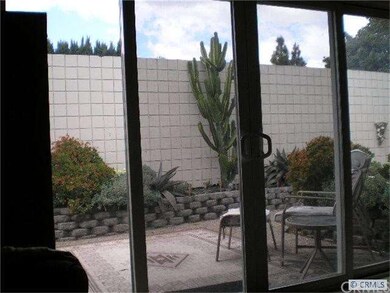 Living room opens to secluded backyard.