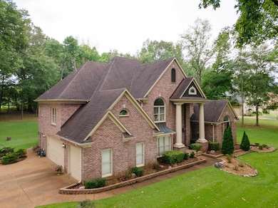View of front of house featuring a front yard and a garage