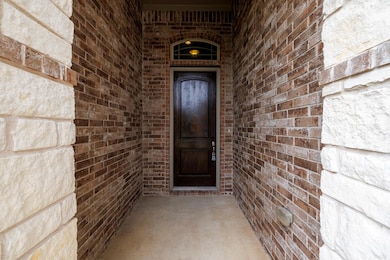 Property entrance featuring brick siding