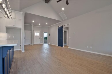 Unfurnished living room with a barn door, ceiling 