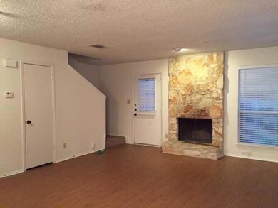 Unfurnished living room featuring a textured ceil
