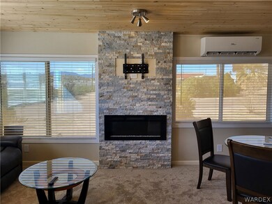 Carpeted living room featuring wood ceiling, plent