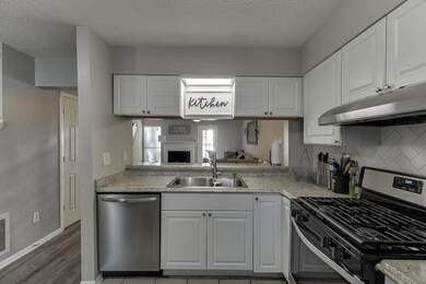 Kitchen featuring stainless steel appliances, a si